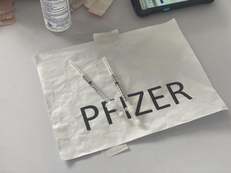  A couple of Pfizer-BioNTech vaccines at the Miami Dade College North Campus, sitting on a sheet of paper that reads Pfizer, at a FEMA-supported site for COVID-19 vaccinations.