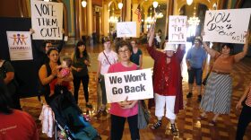 When Iowa Gov. Kim Reynolds signed Iowa's new abortion bill into law, protesters gathered outside her office at the Statehouse in Des Moines. Two groups have now filed a lawsuit to block the bill. CREDIT: Charlie Neibergall/AP