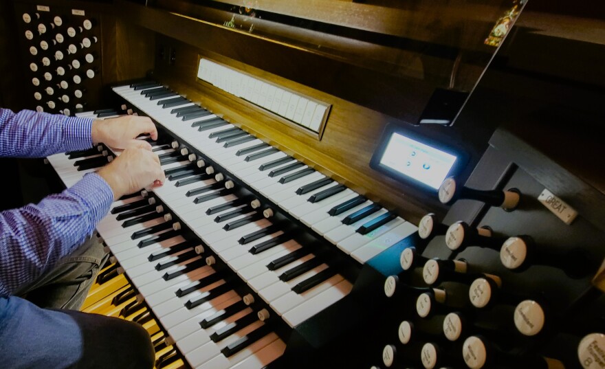 Digital screens that help access music selections are just one of the updated made to the partially updated organ in the Immaculate Conception Catholic Church's choir loft as parish music director James Foxwell plays it.