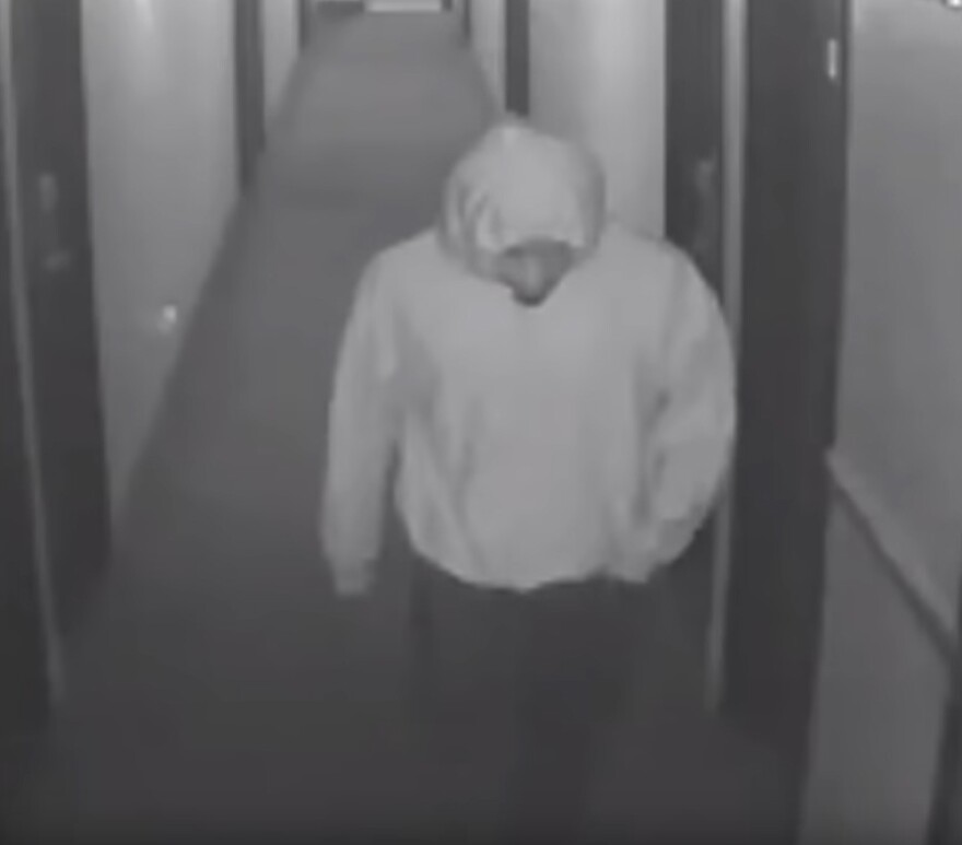 Suspect walks down hallway