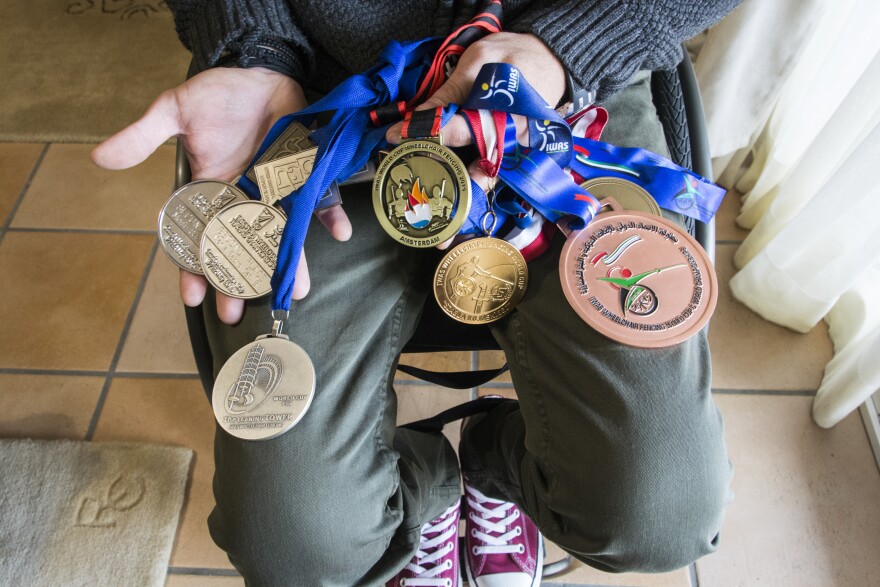 Triantafyllou shows some of the medals he's won over the years, including the gold he won last November at the Wheelchair Fencing World Cup in Amsterdam.