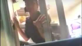 An unidentified worker refuses to take a woman's order in English at a Taco Bell restaurant in Hialeah this week.