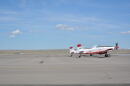 A firefighting plane sits on a runway.