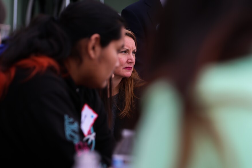 Representative Melanie Stansbury (center) sits in on one of the group discusses during Saturday's Youth Summit