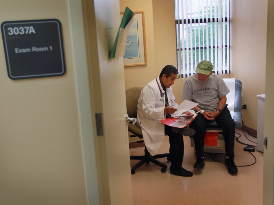 A man gets a checkup from Dr. Olveen Carrasquillo at the University of Miami's Miller School of Medicine in January.
