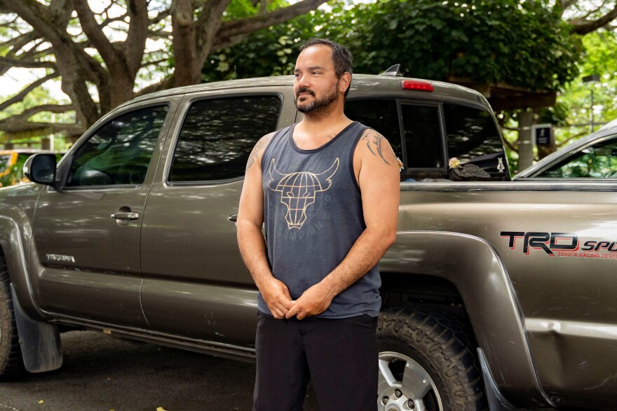 Kimeona Kane poses in front of his pickup truck in Kailua, Hawaiʻi.