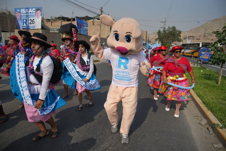 Supporters of a presidential candidate dance in the street