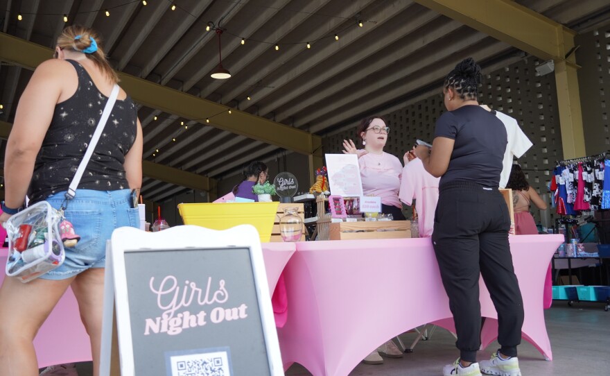 Attendees browse the GNO Events table at Girls Night Out at the Ocala Downtown Market in Ocala, Fla., on June 6, 2026, a monthly event promoting women‑owned businesses.