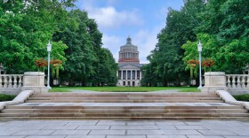Stone steps lead up to the main courtyard on the University of Rochester campus, with the Rush Rhees Library in the background.
