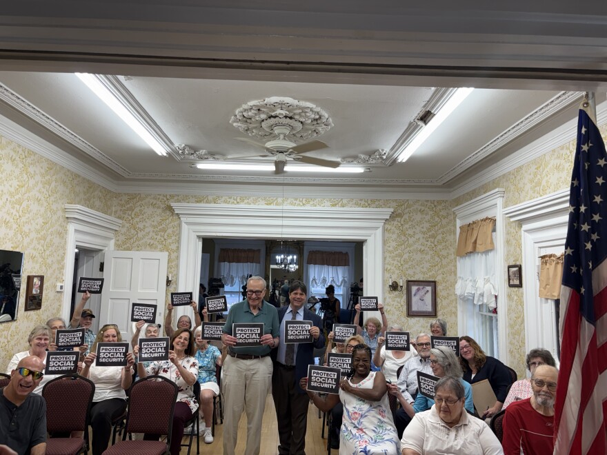Senator Chuck Schumer, Glens Falls Mayor Bill Collins, and members of the Glens Falls Senior Center