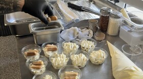 Manager Jackson Zheng, 26, dips lady fingers into homemade coffee mixture and places them atop a bed of mascarpone creme to create tiramisu. He then topped the dessert with additional creme and cocoa powder.