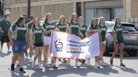 Members of the host team, Greater Wyoming Area, march at the front of the parade for the East Region Junior Little League Softball Championship in Nanticoke on Wednesday.