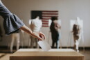 Casting her vote at a ballot box