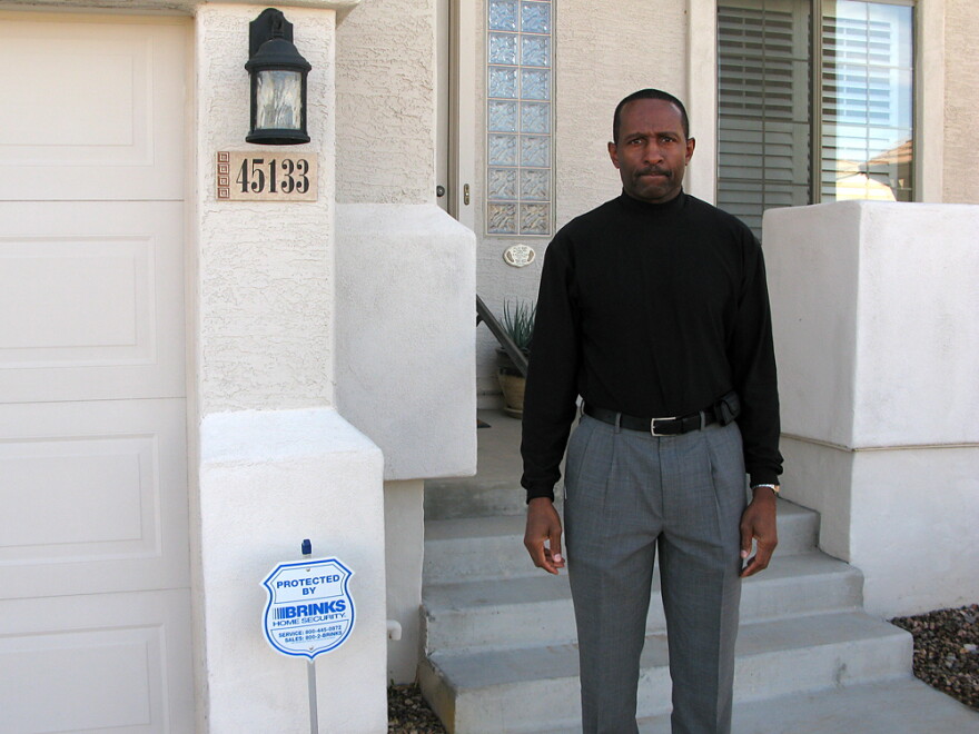 Thad Salter stands in front of the home he bought for $300,000 in 2006. The house in Maricopa, Ariz., is now appraised at $125,000.