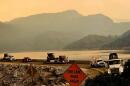 Fire crews drive over Wishon Dam in Fresno County as they respond to the Garnet Fire