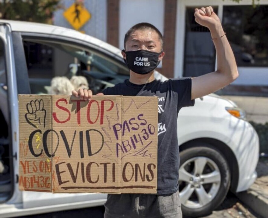 Eugene Vang, 19, demonstrates against evictions during the COVID-19 pandemic near his hometown in Merced County.