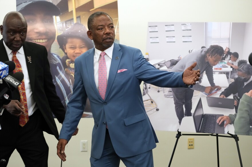 Lawyers Benjamin Crump, left, and Carl Douglas, right, held a news conference in January to announce their filing of a $50 million claim against the city of Los Angeles over the death of Keenan Anderson, who is pictured on posters.