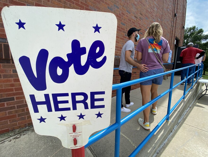 Voters line up outside Chapel Lakes Elementary School in Lee’s Summit on Tuesday afternoon. Masks, hand sanitizer, social distancing and free stylus pens were the order of the day. One candidate’s proxy was even handing out tiny personal packets of sanitizer wipes to voters with her candidate’s name glued to the foil packet.