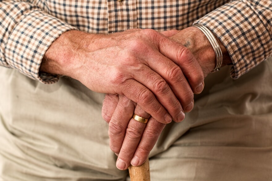 elderly man holding hands