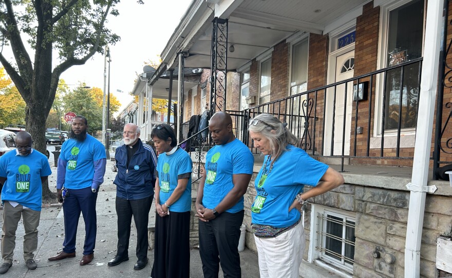  In the middle is Rev. George Hopkins, who leads the community organizers in a word of prayer. 