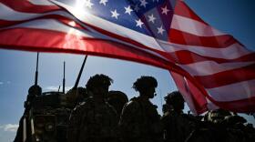 U.S. Army soldiers stand in formation next to a US flag and a U.S. Army armoured vehicle as they take part in the NATO "Noble Blueprint 23" joint military exercise at the Novo Selo military ground, northwestern Bulgaria, on September 26, 2023. (Nikolay Doychinov/AFP via Getty Images)
