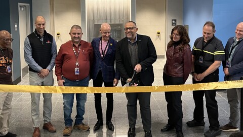 Officials cut the ribbon at new restrooms at the centralized security checkpoint at Cleveland Hopkins International Airport. The new bathrooms include universal changing tables to accommodate people with disabilities.