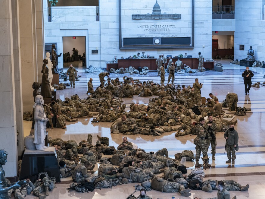 Hundreds of National Guard troops hold inside the Capitol Visitor's Center to reinforce security at the Capitol on Wednesday.