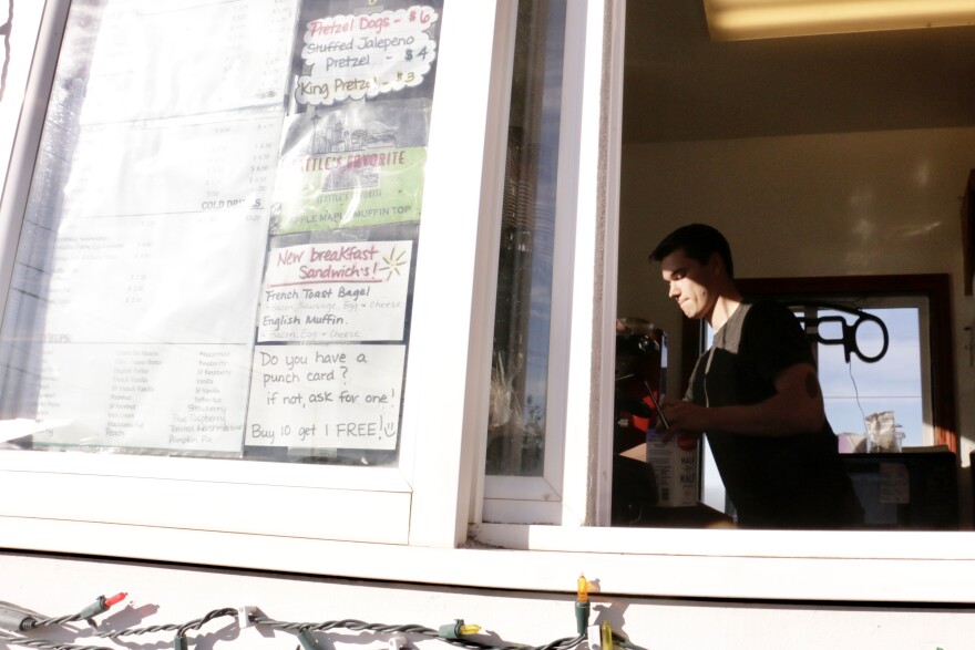 At the drive-thru window of AM Coffee & Espresso, new employee Jonah Koonce preps his next order. Before coming to Bethel, Koonce trained baristas at Kaladi Brothers in Anchorage for several years. 