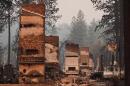 Chimneys are the only structures remaining in a residential neighborhood after a wildfire hit the northern part of Spokane, Wash., Monday, Aug. 3, 2026. (Lindsey Wasson/AP)