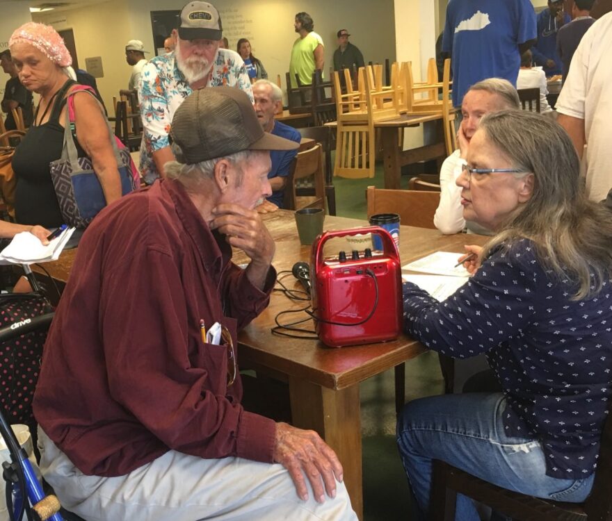 Ginny Ramsey with Catholic Action Center clients during a community meeting.