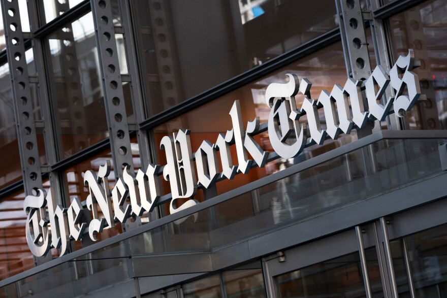 FILE - A sign for The New York Times is displayed above the entrance to its building in New York on May 6, 2021. (AP Photo/Mark Lennihan, File)
