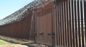 Closed door in metal border fence