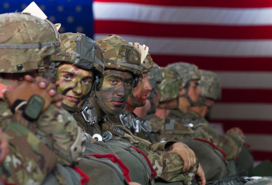 Paratroopers with the 82nd Airborne Division wait after being fitted with parachutes for an upcoming training jump at Fort Bragg, N.C. on July 26, 2017.