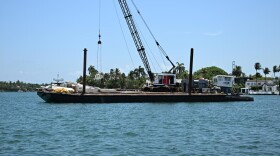 The barge from the vessel collision near Hibiscus Island, July 28, 2025. Coast Guard Sector Miami crews are investigating the potential causes of the collision.