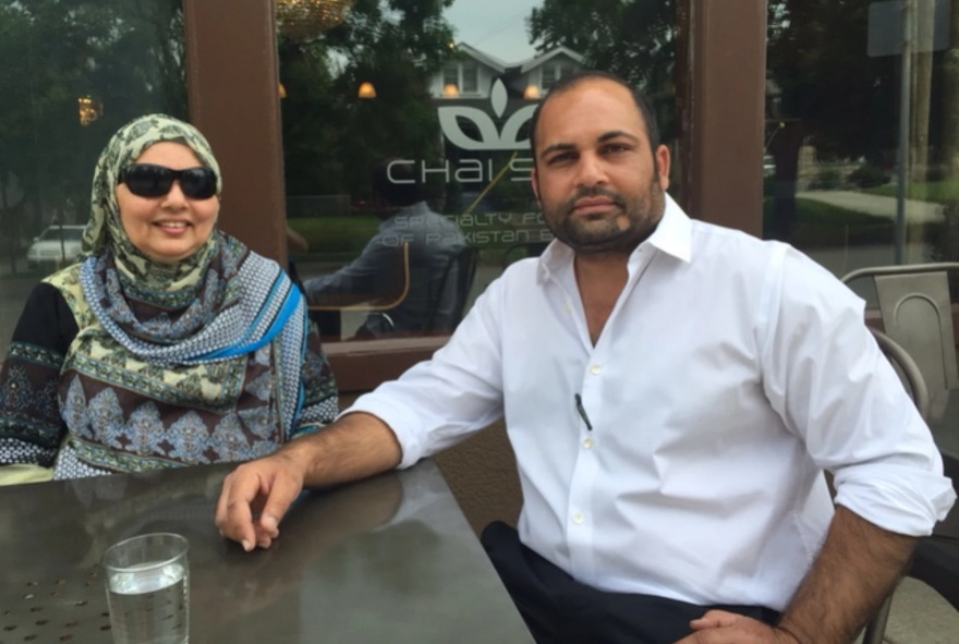 Kashif Tufail sits with his mother, Asama Tufail, outside of Chai Shai, where customers have been taking food to-go for the past ten years.