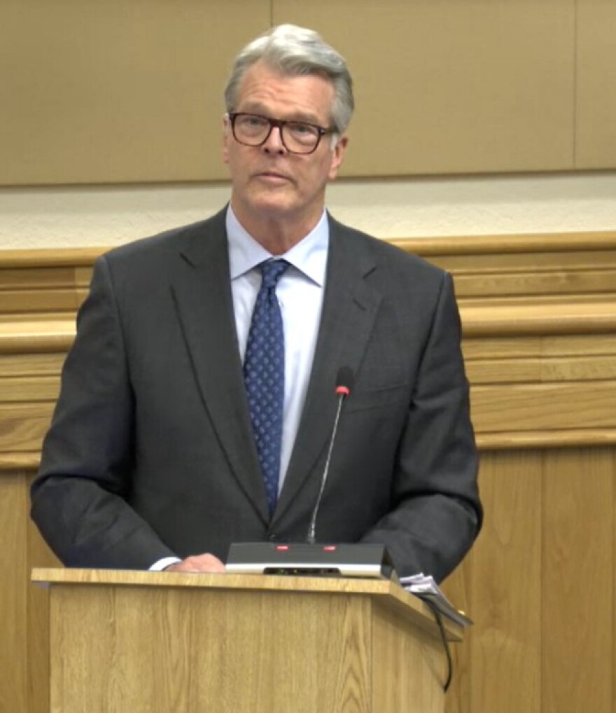 Man speaks at podium 