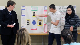 Students present a project during the inaugural Art, History and Science Fair.