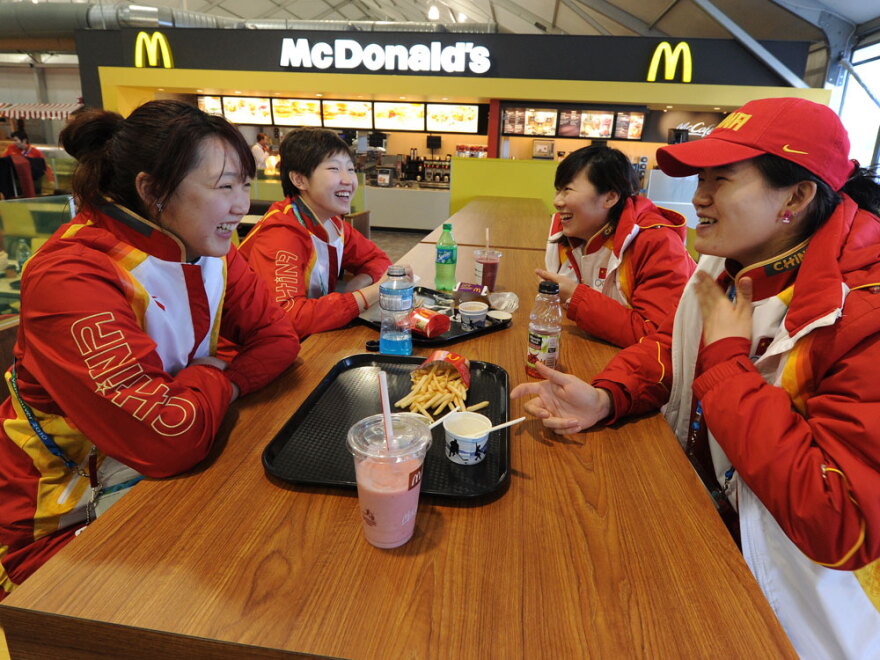 Chinese short-track speedskaters eat in the dining hall during a media tour of the Olympic Village in downtown Vancouver on Feb. 9.