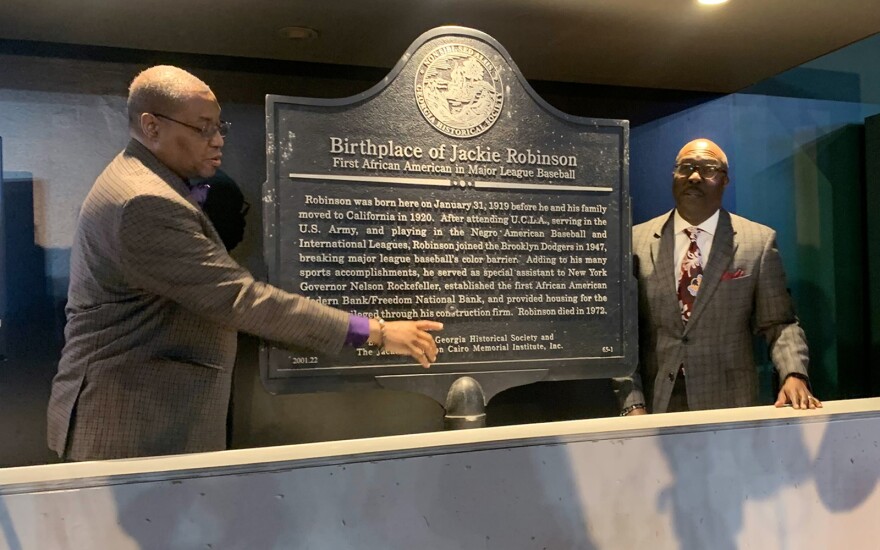 Negro Leagues Baseball Museum President Bob Kendrick, right, and Vice President Raymond Doswell talk about the defaced Jackie Robinson Birthplace historical marker the museum unveiled Friday morning.