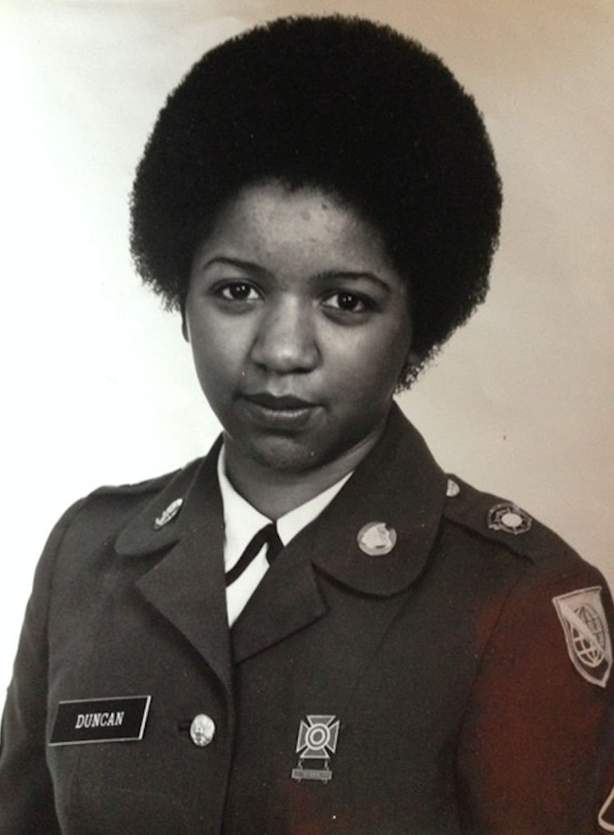 A black-and-white headshot of Perez in military full dress and an afro