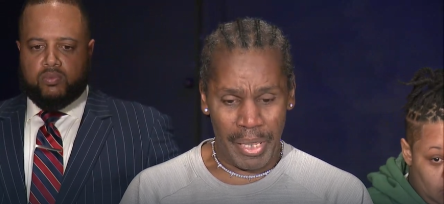 Efrem Frazier (center), Jazmir Tucker's great uncle, speaks at a press conference announcing a lawsuit against the city of Akron. 