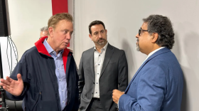 Gov. Ned Lamont, Chris DiPentima of the Connecticut Business and Industry Association and Max Kothari, owner of Express Kitchens in Hartford and chair of the Hartford Chamber of Commerce, speak at a press conference on Jan. 18, 2023.