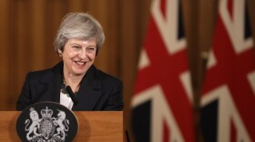 Britain's Prime Minister Theresa May smiles during a press conference inside 10 Downing Street in London, Thursday, Nov. 15, 2018. British Prime Minister Theresa May says if politicians reject her Brexit deal, it will set the country on "a path of deep and grave uncertainty." Defiant in the face of mounting criticism, May said Thursday she believed "with every fiber of my being" that the deal her government struck with the European Union was the right one. (Matt Dunham, Pool/AP)