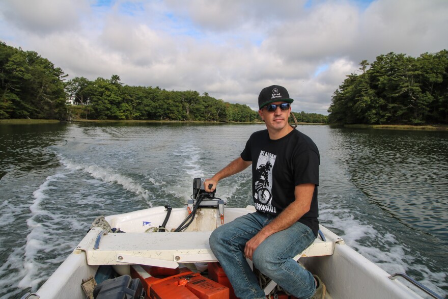 Nick Planson steers his electric boat on Cousins River in Yarmouth, Maine.