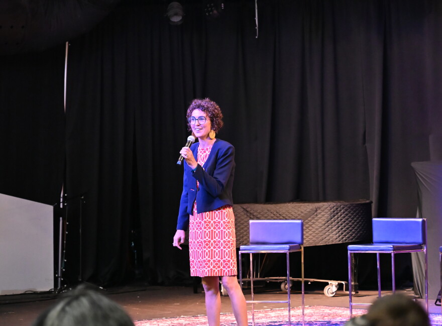 University of Tulsa professor of economics Clara Mattei stands on stage to speak to Tulsa residents during a forum organized by the Forum for Real Economic Emancipation.