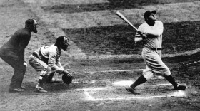 Babe Ruth clouts a towering home run during his time with the New York Yankees.