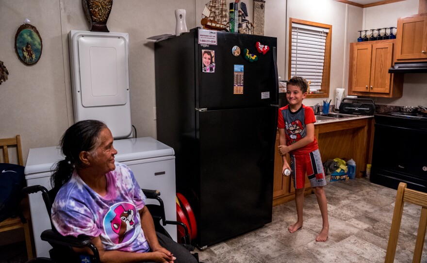 Ethel Dardar speaks with her grandson Jayden Dardar in their FEMA trailer in Pointe-aux-Chenes.