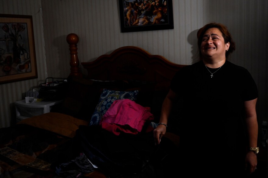 On a day filled with unexpected memories, Glenda Cardenas is brought again to sobbing tears putting the clothes she found in the attic in the bedroom she shared with her late husband Miguel Torres. She keeps the door to this room closed. She will not go in, and won’t sleep in the bedroom. Waterbury, Connecticut May 28, 2021.