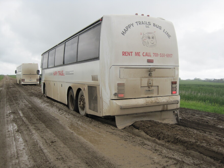 Two buses full of people are stuck on a county road near Crary, ND during a tour of Devils Lake flood waters.
