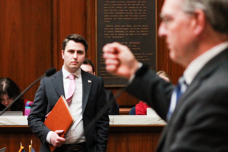 Rep. Andrew Ireland (R-Indianapolis), left, watches as Rep. Matt Pierce (D-Bloomington), right, speaks about SB 326 on the House floor on March 31, 2025.